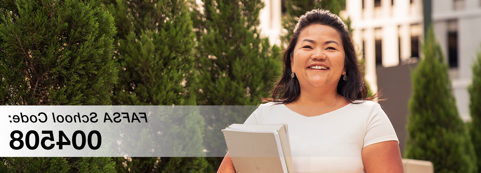 female student holding book with text on photo: FAFSA School Code – 004508